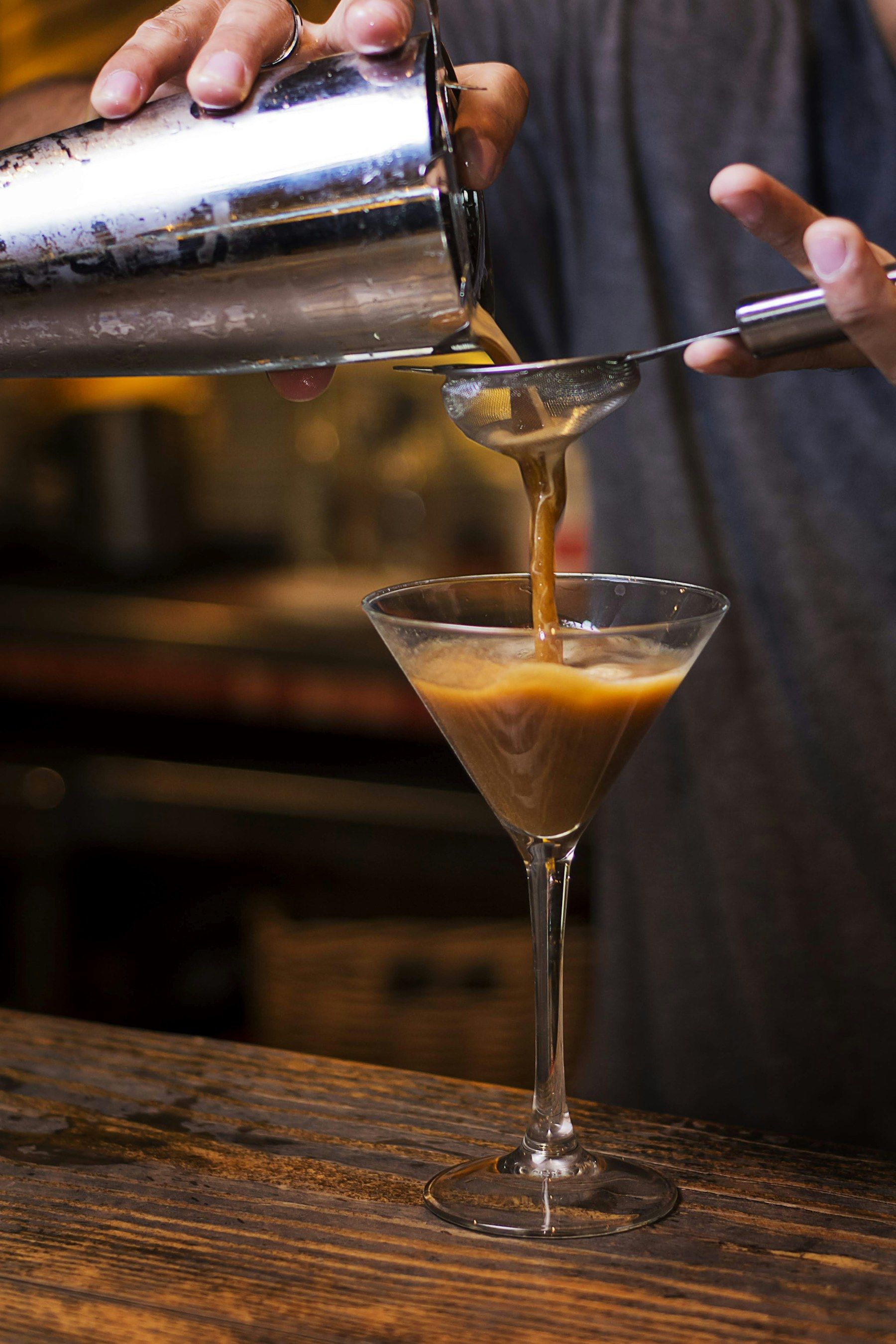 A martini being poured at the bar
