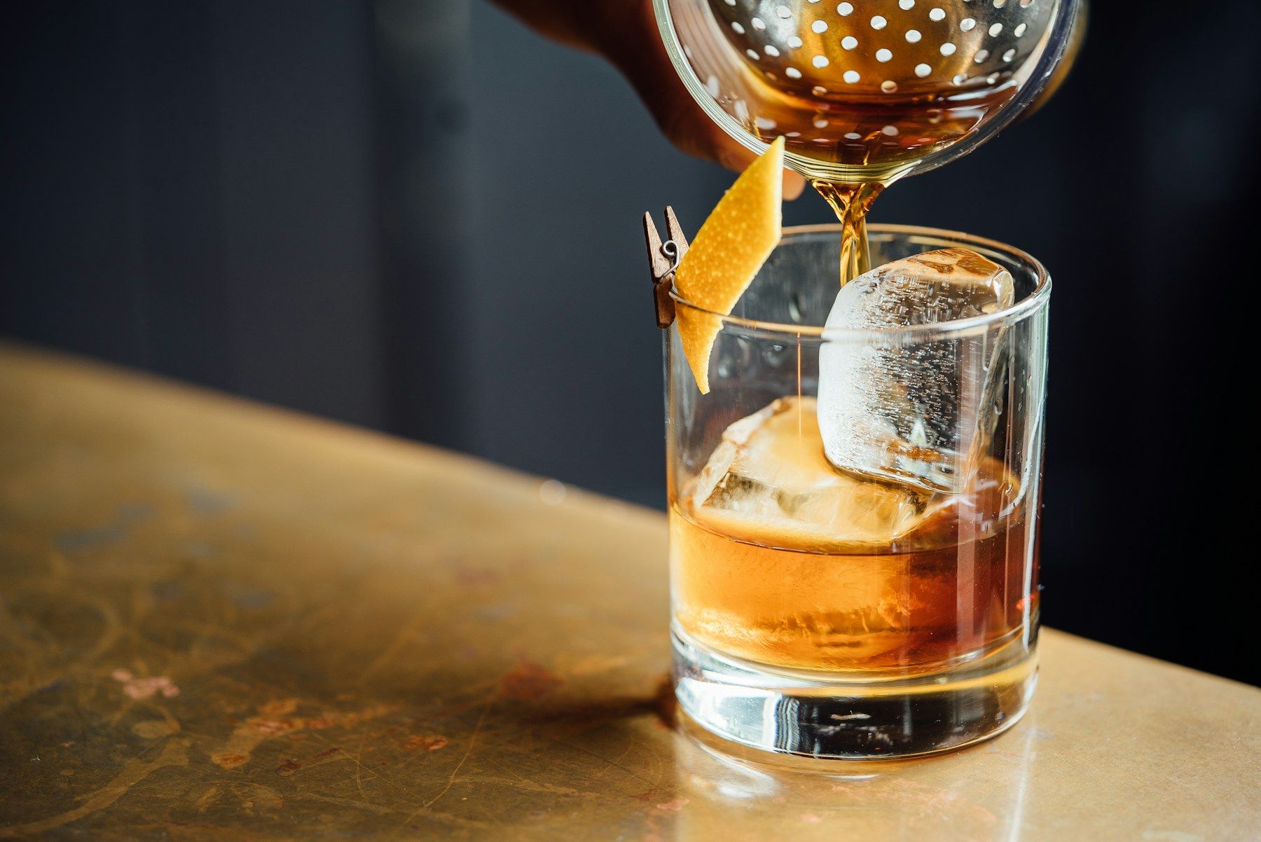 A spirit poured over a large ice cube