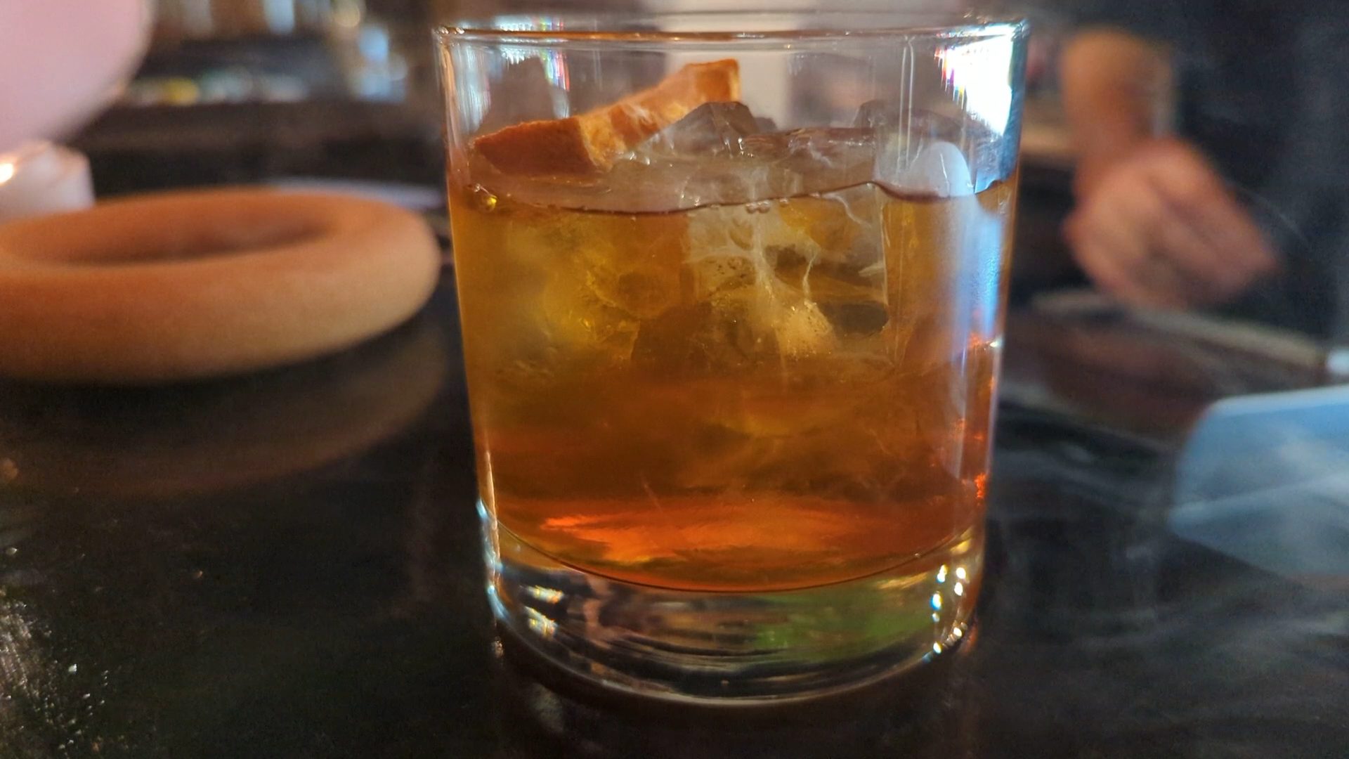 A stirred cocktail over ice with an orange twist at Garf's