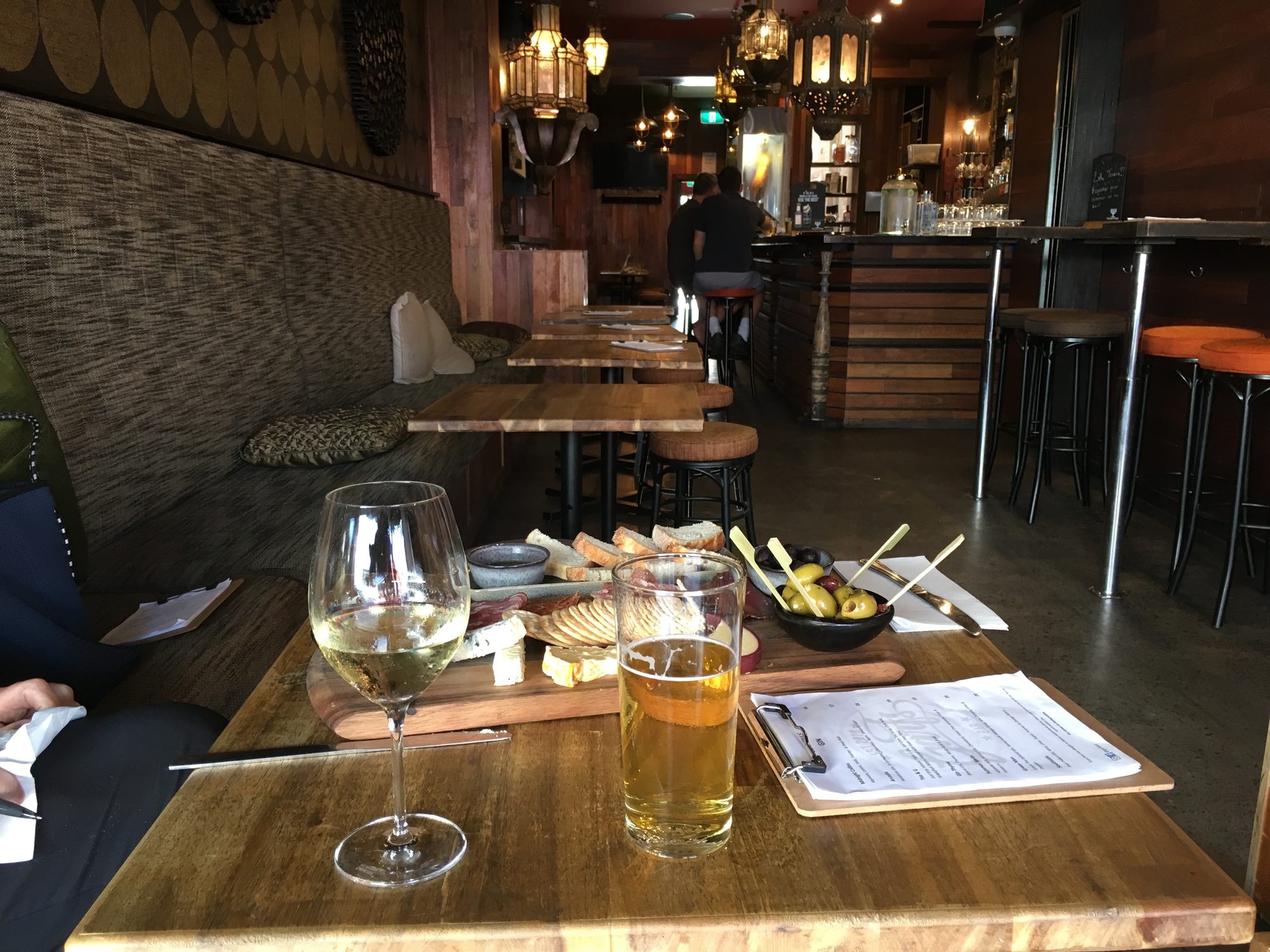 The room at Garf's, timber tables, booths and a warm lit bar